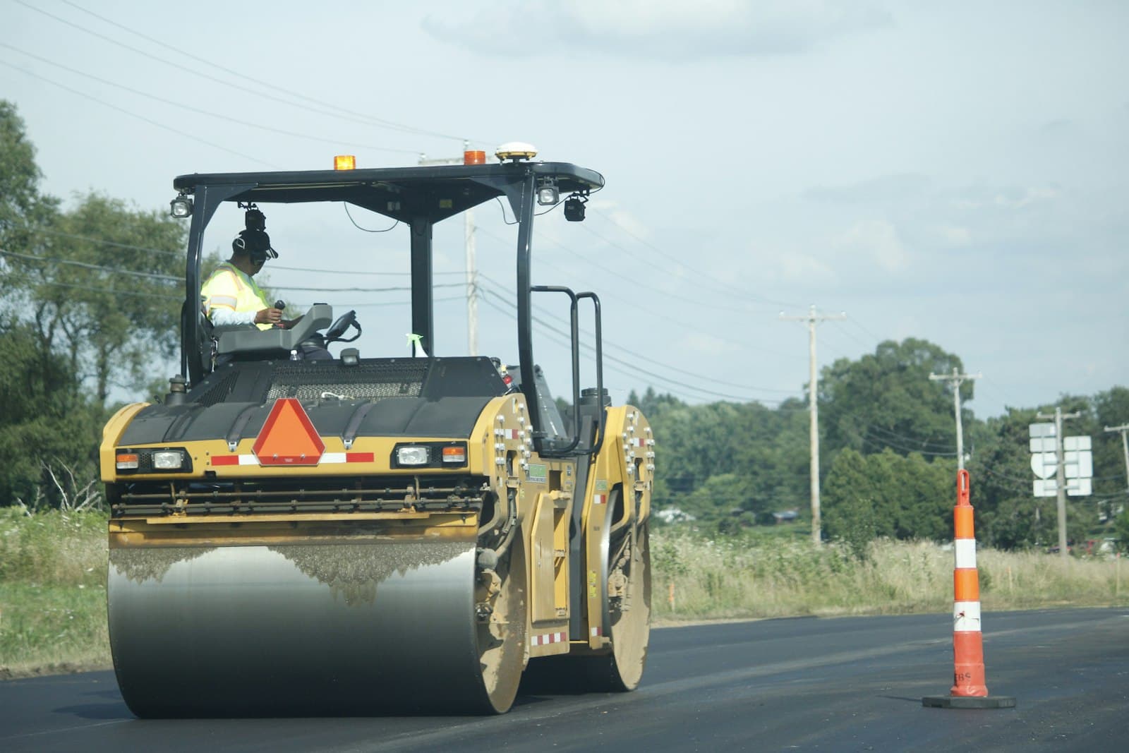 Roller compacting fresh asphalt, CraftWell Group London Ontario